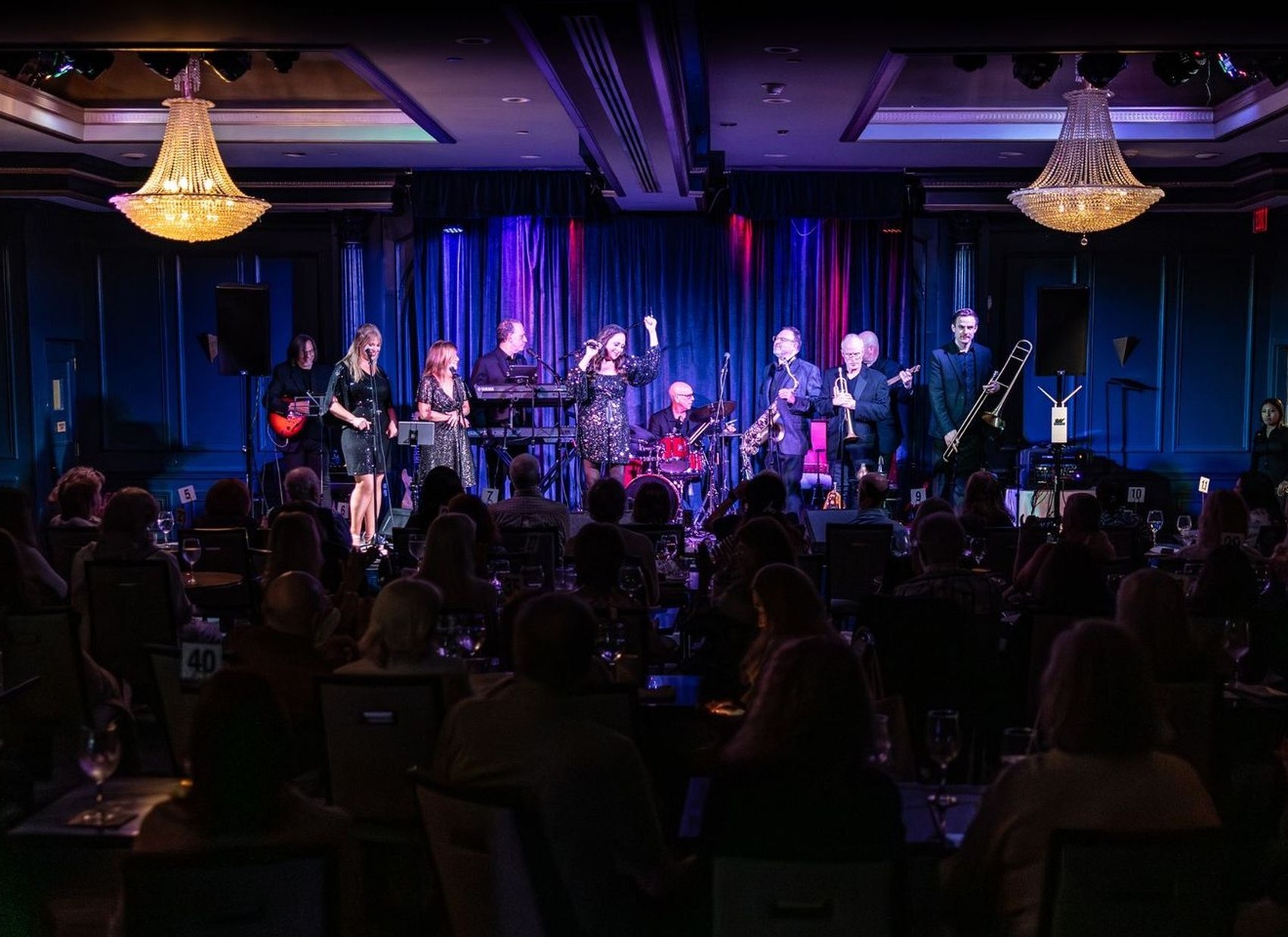 What the World Needs Now — 10-piece Burt Bacharach tribute band performing live on stage in an elegant ballroom with chandeliers